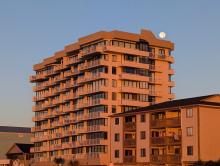 Sunrise with Full Moon Over Building